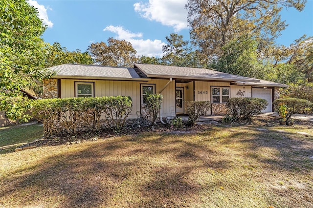 single story home with a garage and a front yard