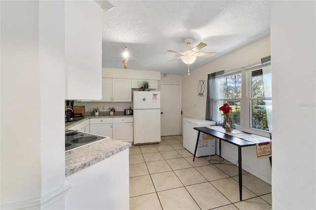 kitchen featuring ceiling fan, white fridge, white cabinetry, and a textured ceiling