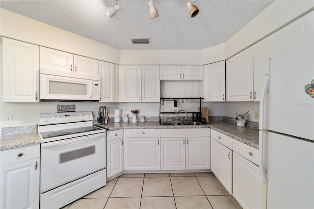 kitchen featuring a textured ceiling, sink, white cabinets, and white appliances