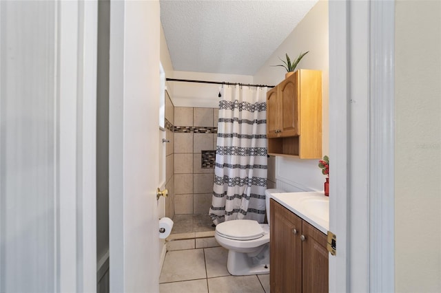 bathroom with walk in shower, tile patterned flooring, a textured ceiling, toilet, and vanity