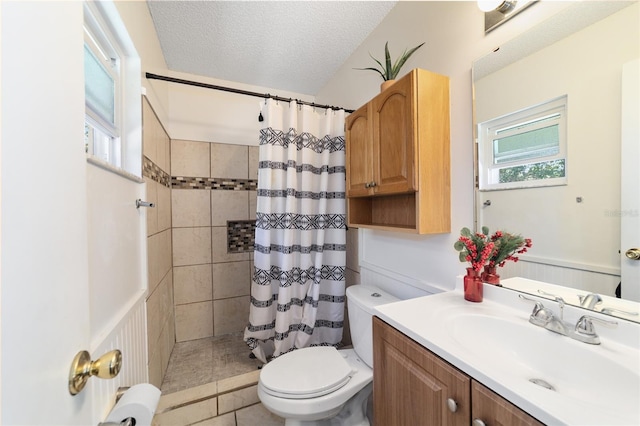 bathroom with a shower with curtain, a healthy amount of sunlight, and a textured ceiling