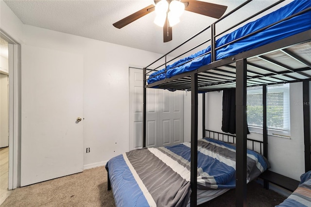 bedroom featuring carpet, a textured ceiling, and ceiling fan