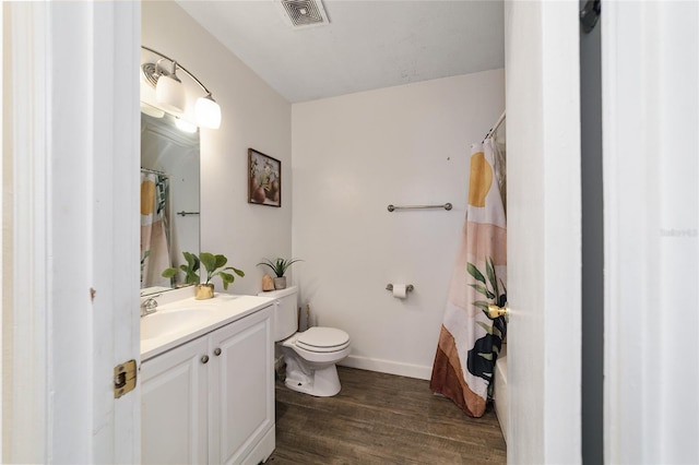 bathroom with hardwood / wood-style flooring, vanity, and toilet