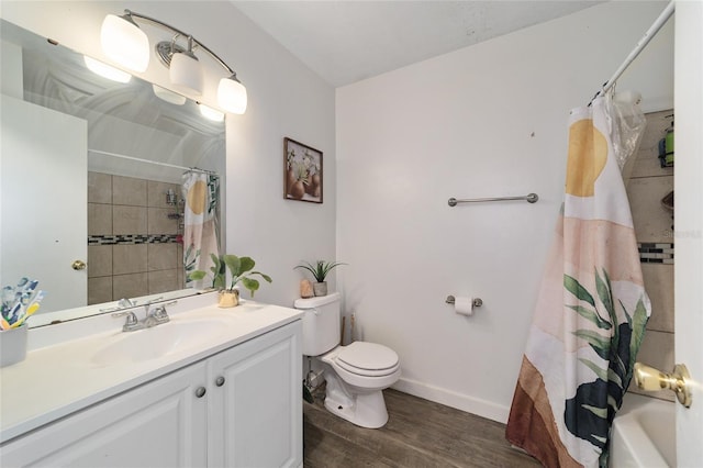 full bathroom with shower / bath combo, vanity, hardwood / wood-style flooring, and toilet