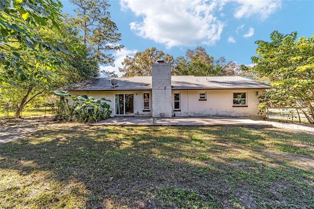 back of house featuring a yard and a patio