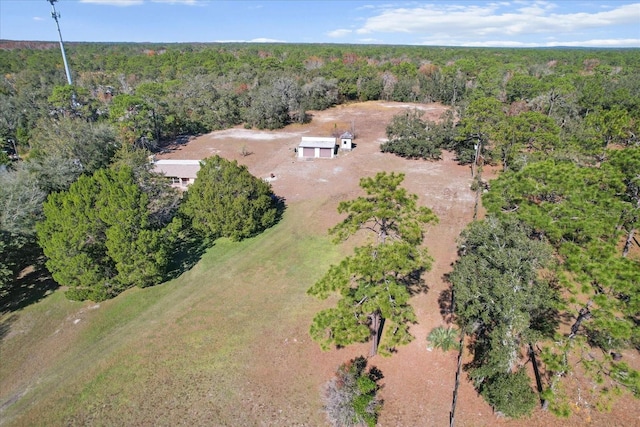 birds eye view of property with a forest view