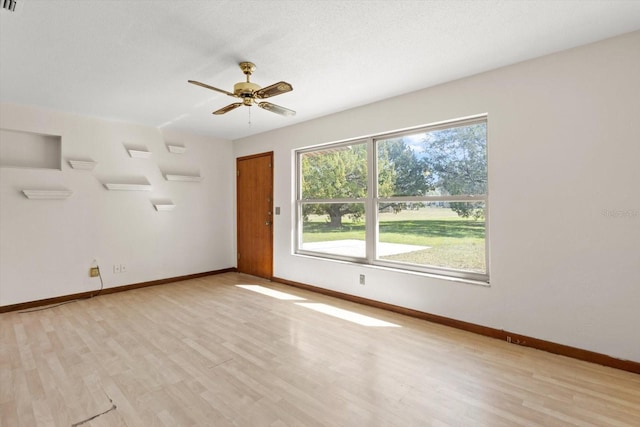 unfurnished room featuring light wood-style flooring, baseboards, and ceiling fan