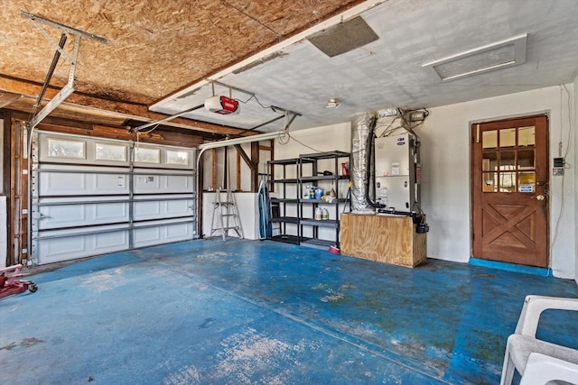 garage featuring heating unit and a garage door opener