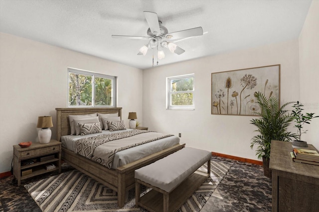 bedroom featuring a ceiling fan and baseboards