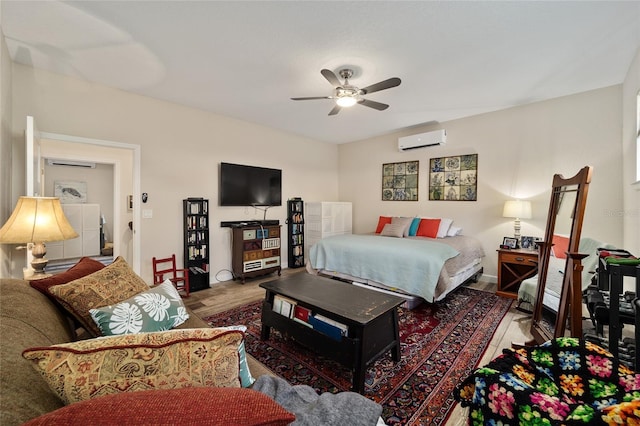 bedroom featuring a wall unit AC, ceiling fan, and hardwood / wood-style flooring