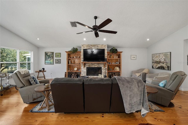 living room with a fireplace, ceiling fan, light hardwood / wood-style flooring, and lofted ceiling