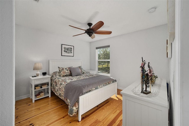 bedroom with light hardwood / wood-style flooring and ceiling fan