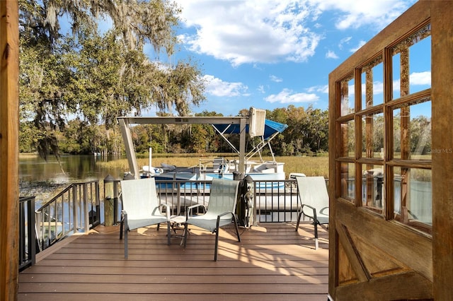 wooden deck with a water view and a boat dock