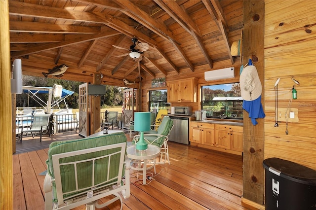 wooden terrace featuring an AC wall unit, ceiling fan, and exterior kitchen