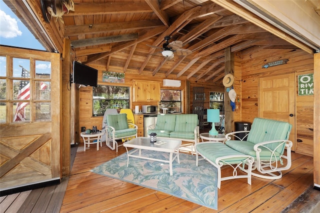 living area with wooden ceiling, lofted ceiling with beams, wooden walls, ceiling fan, and dark hardwood / wood-style floors