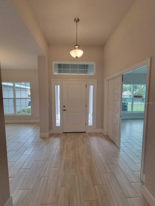 entrance foyer with light wood finished floors and baseboards