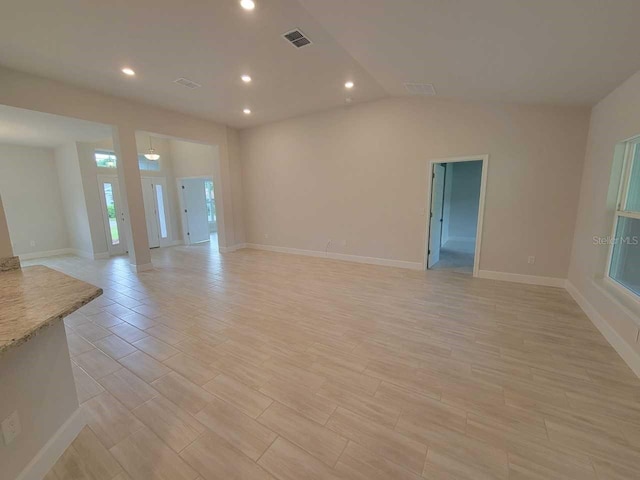 unfurnished living room with recessed lighting, light wood finished floors, visible vents, and baseboards