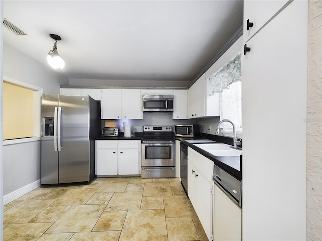 kitchen with white cabinets, sink, and appliances with stainless steel finishes