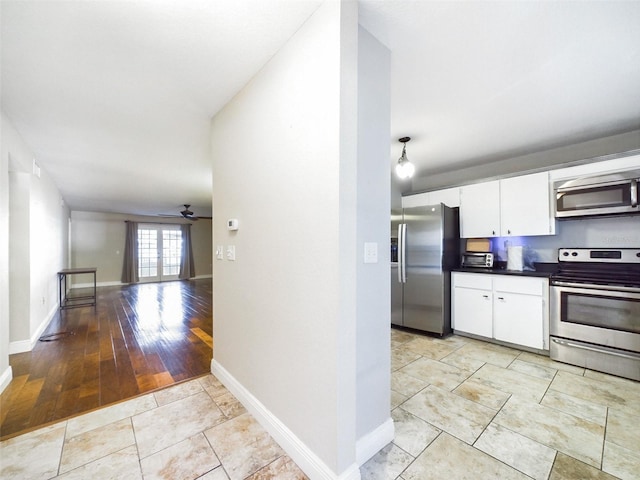 kitchen featuring white cabinets, ceiling fan, light hardwood / wood-style floors, and appliances with stainless steel finishes