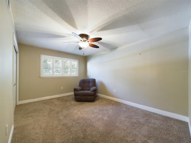 unfurnished room featuring ceiling fan, carpet, and a textured ceiling