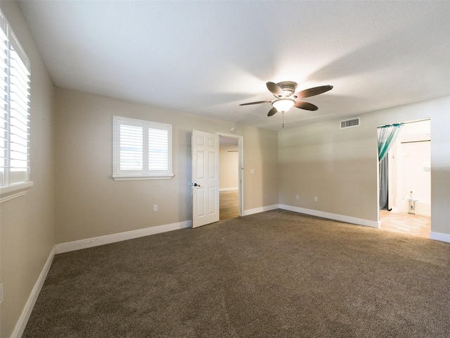 carpeted empty room featuring ceiling fan