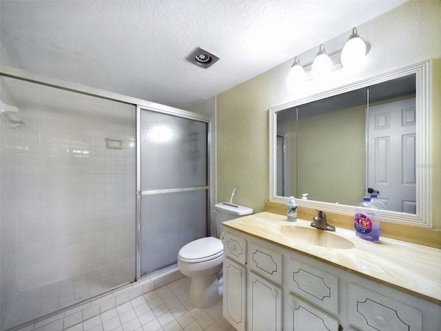 bathroom with tile patterned flooring, a textured ceiling, toilet, vanity, and a shower with shower door