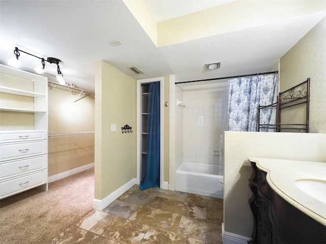 bathroom with shower / tub combo, vanity, and a textured ceiling