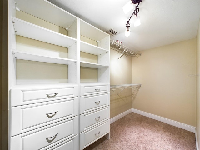 walk in closet featuring carpet