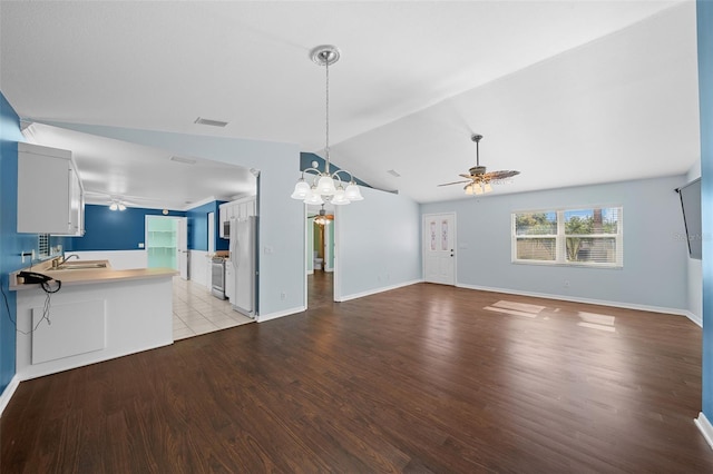 unfurnished living room featuring sink, ceiling fan with notable chandelier, light hardwood / wood-style floors, and lofted ceiling