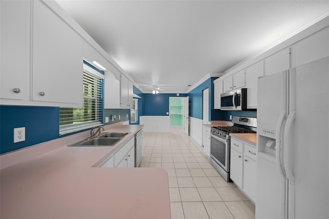 kitchen with white cabinets, ceiling fan, sink, and appliances with stainless steel finishes