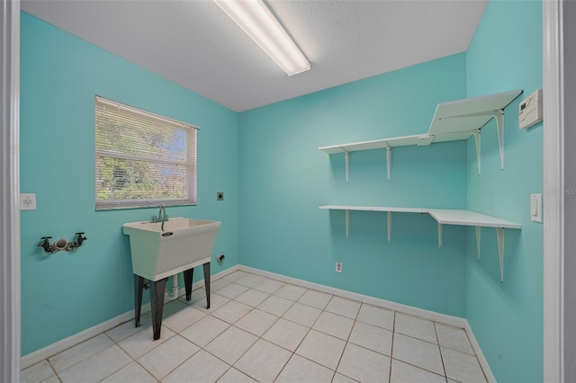 washroom with light tile patterned floors and hookup for an electric dryer