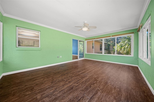 empty room with hardwood / wood-style flooring, plenty of natural light, and ornamental molding