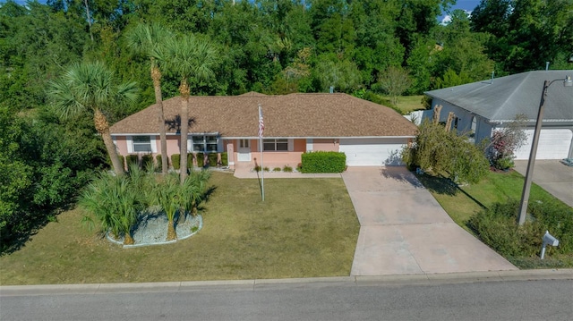 view of front of house featuring a front lawn and a garage