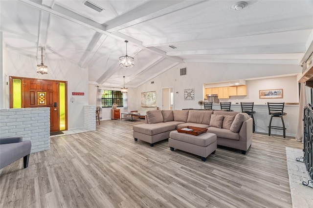 living room featuring beam ceiling, light wood-type flooring, and high vaulted ceiling