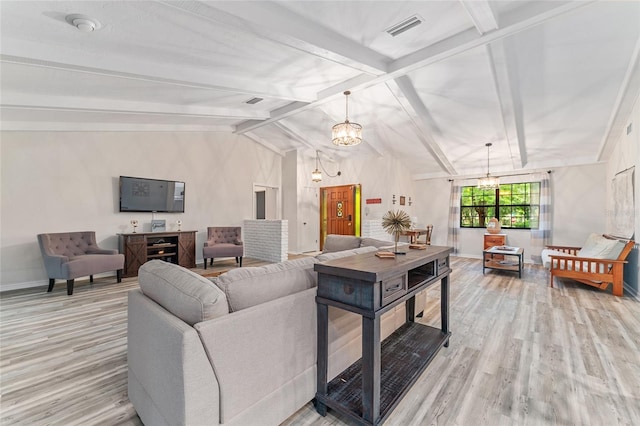 living room featuring a chandelier, light wood-type flooring, and vaulted ceiling with beams