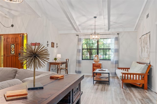 interior space featuring beamed ceiling, hardwood / wood-style floors, and an inviting chandelier