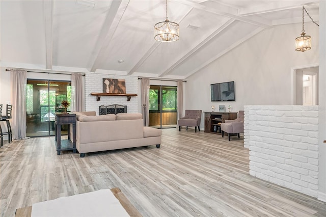 living room with a fireplace, high vaulted ceiling, an inviting chandelier, light hardwood / wood-style flooring, and beamed ceiling