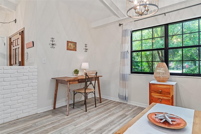 interior space featuring light hardwood / wood-style floors, beam ceiling, and an inviting chandelier