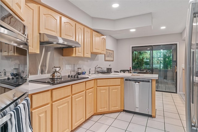 kitchen featuring sink, kitchen peninsula, light brown cabinetry, light tile patterned floors, and appliances with stainless steel finishes