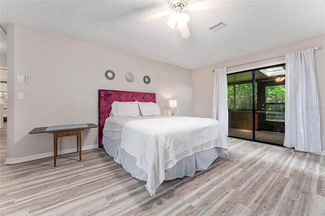 bedroom featuring a textured ceiling, access to outside, ceiling fan, and light hardwood / wood-style floors