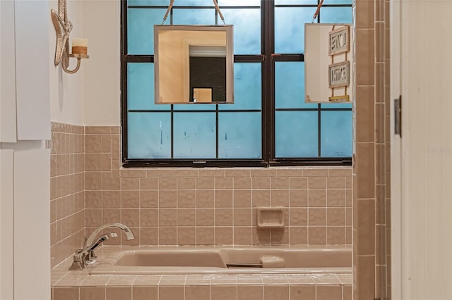 bathroom featuring a relaxing tiled tub