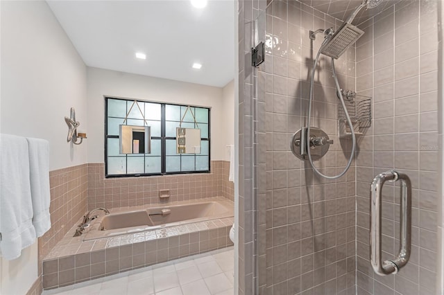 bathroom with tile patterned floors, shower with separate bathtub, and toilet