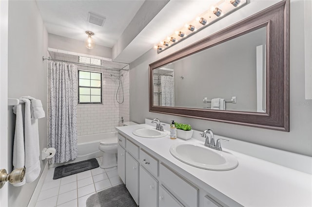 full bathroom featuring tile patterned floors, vanity, toilet, and shower / bath combo with shower curtain