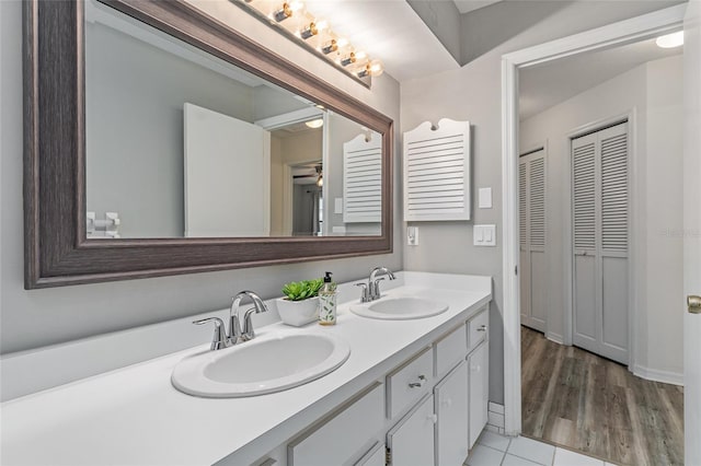 bathroom with ceiling fan, vanity, and hardwood / wood-style flooring