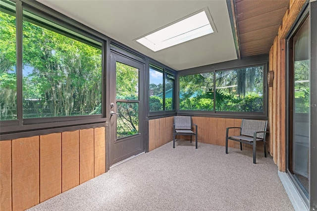 sunroom featuring a skylight, a wealth of natural light, and radiator heating unit