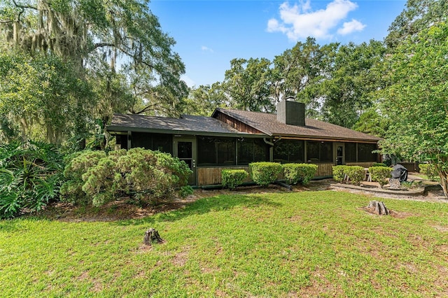 rear view of house with a lawn