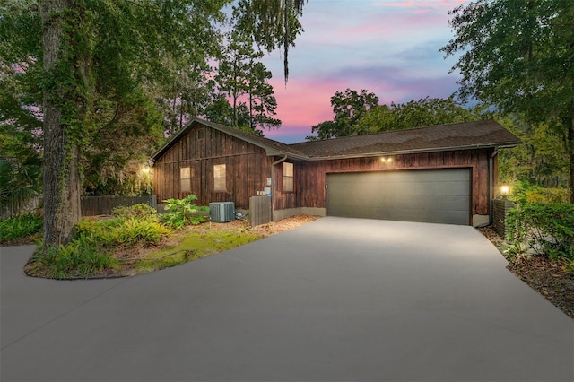 view of front of home featuring a garage and central air condition unit