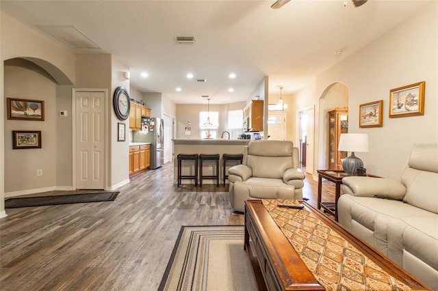 living room featuring hardwood / wood-style floors and sink