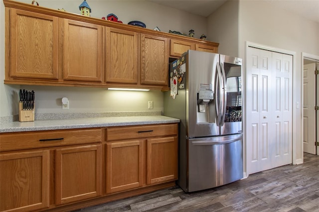 kitchen featuring stainless steel fridge and dark hardwood / wood-style flooring