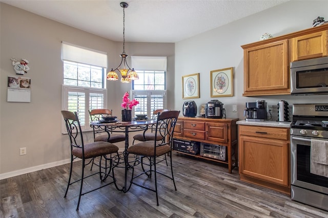 dining room featuring dark wood-type flooring and a notable chandelier